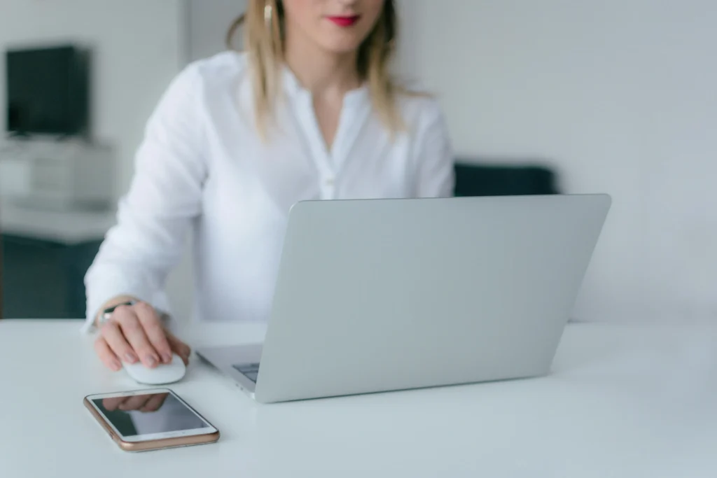 A lawyer sitting at a desk, interacting with a laptop computer.