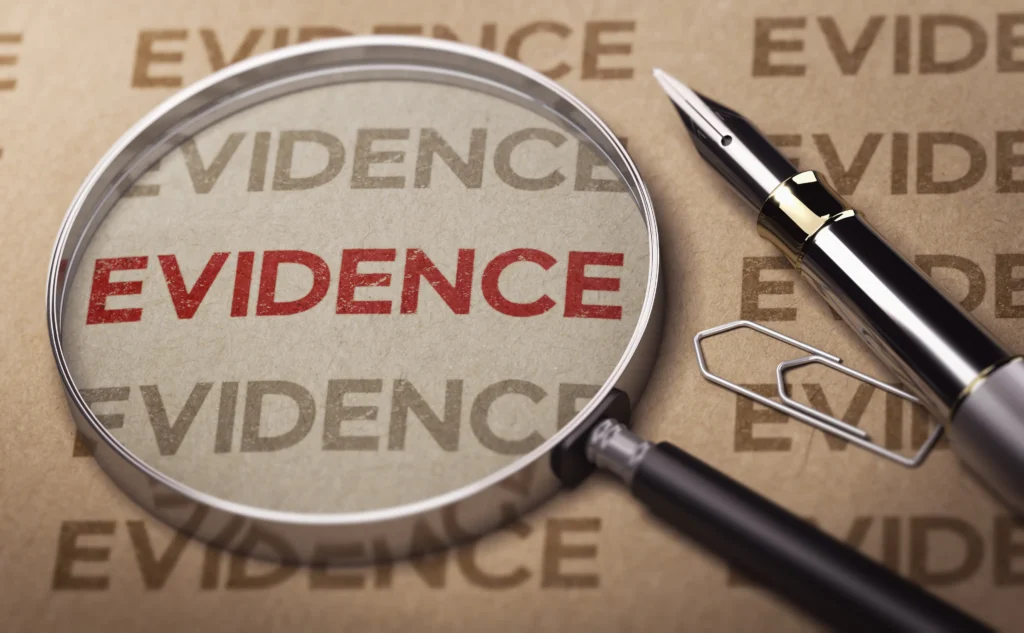 A magnifying glass and the word evidence written in red.