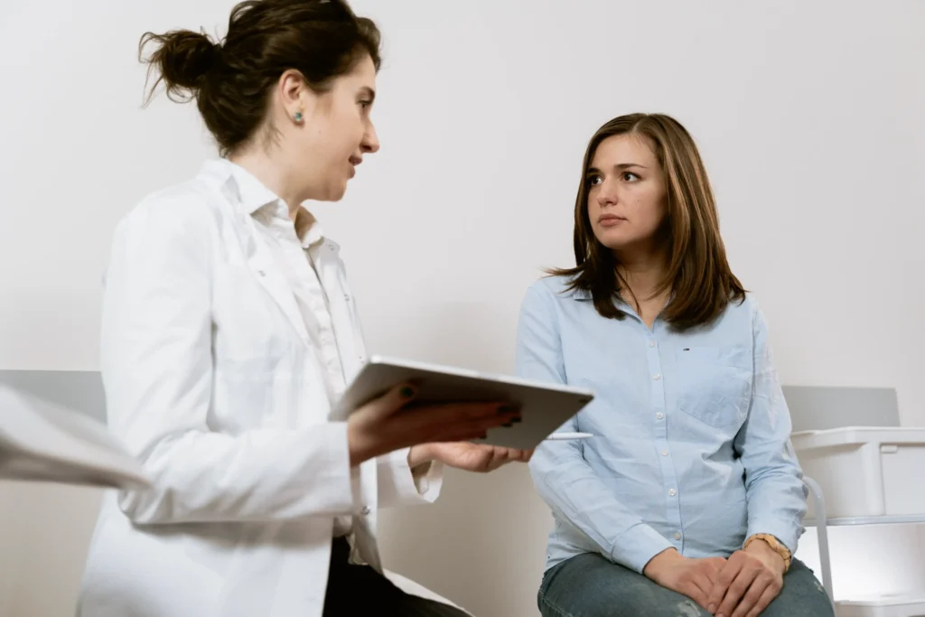 Doctor consulting woman about potential product liability risks.